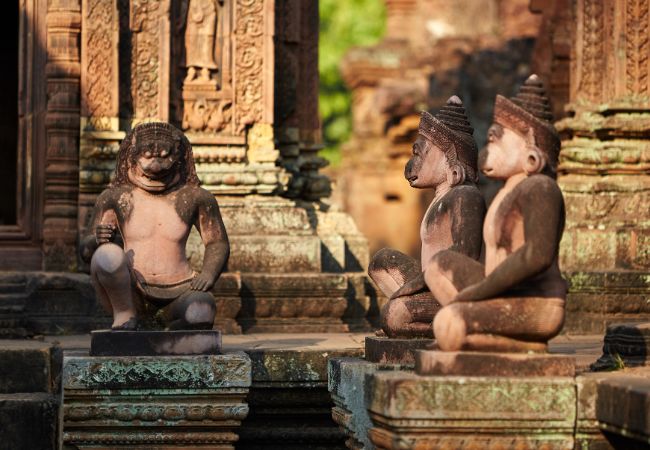 2 kneeling statues of human figures 