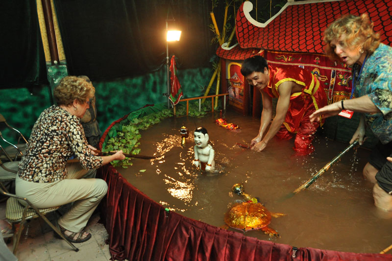 tourists join performing water puppet vietnam tours